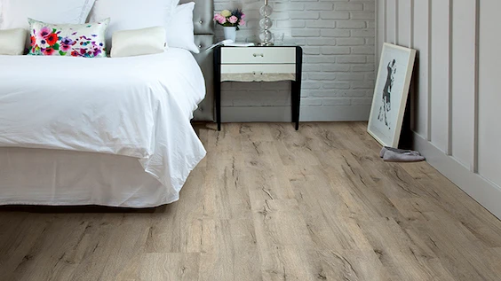 Natural tone wood look luxury vinyl plank flooring in bedroom